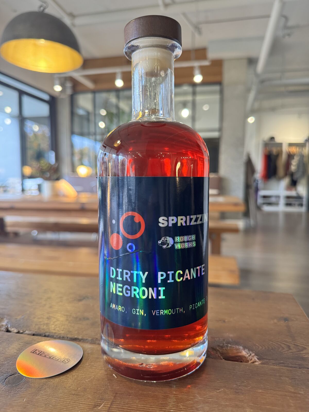 The Dirty Picante Negroni bottle on a table, slate label