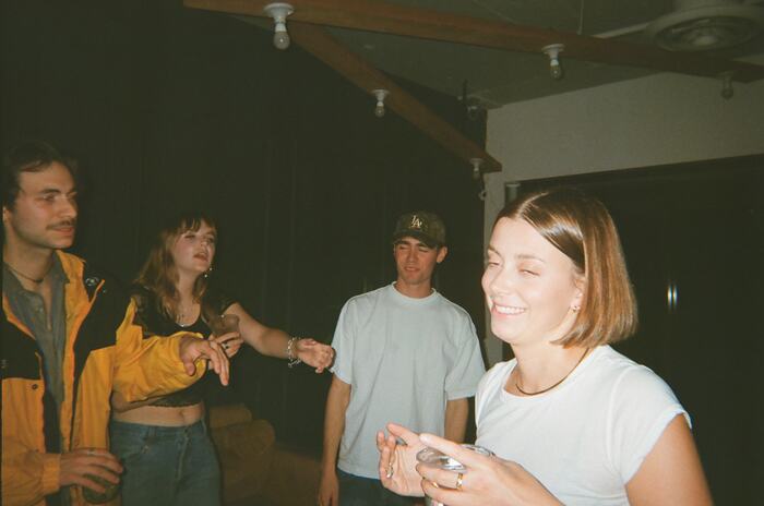 Four guests laughing near the DJ table