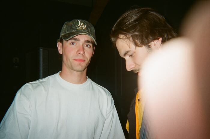 A guest in a camo cap looking straight into the flash