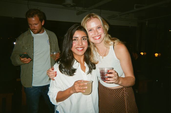 Two guests smiling with their drinks