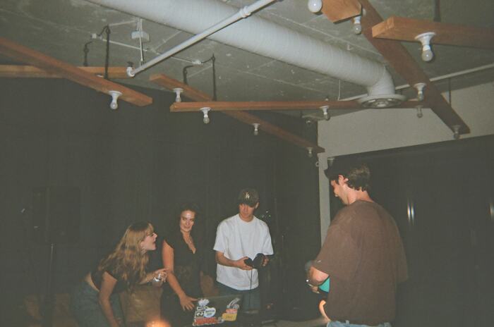 Four guests gathered round the DJ table