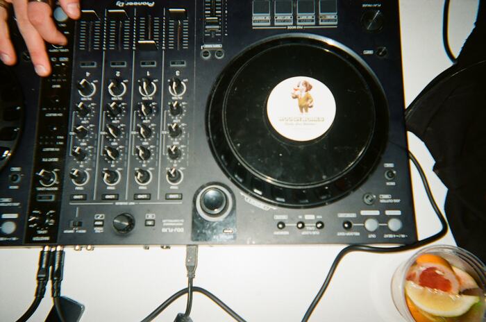 The DJ controller from above with a cup of citrus garnish beside it