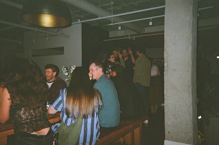 Guests sitting along the long table, laughing