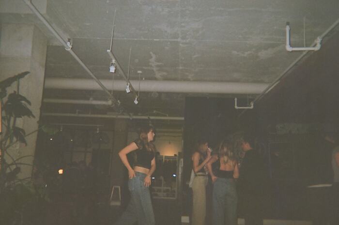 Guests dancing at the far end of the room