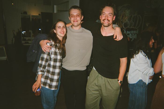 Three guests with their arms round each other