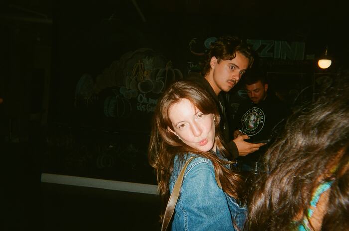 A guest in a denim jacket glancing back at the camera