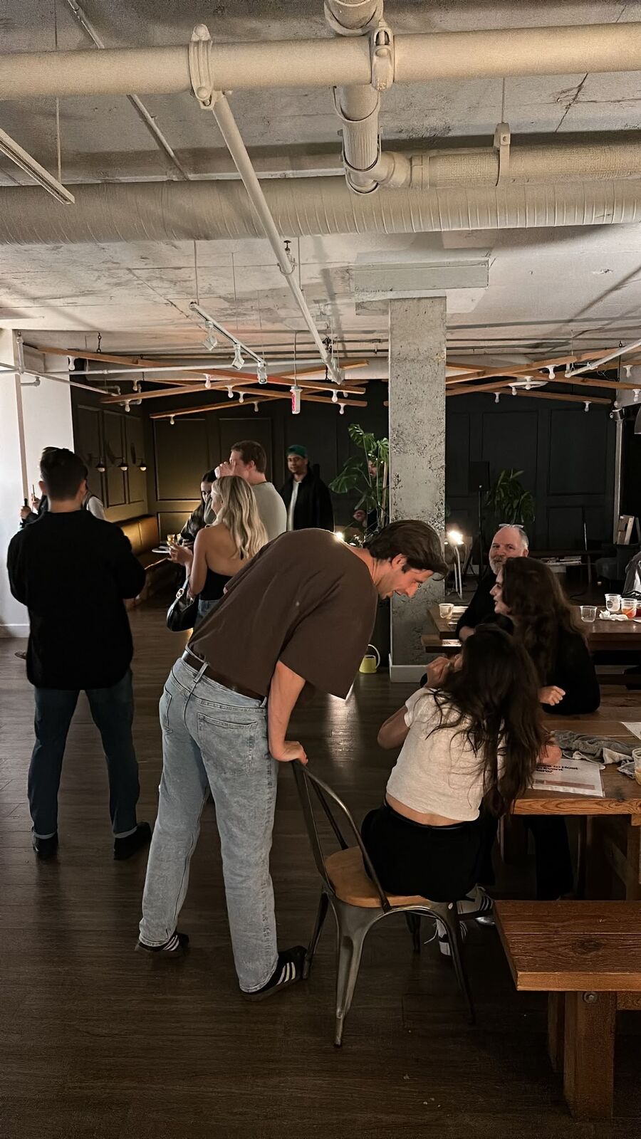 Guests standing and sitting around the long table on the third floor